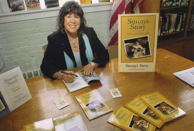 Ginger Katz signing autographed copies of her book Sunny’s Story.